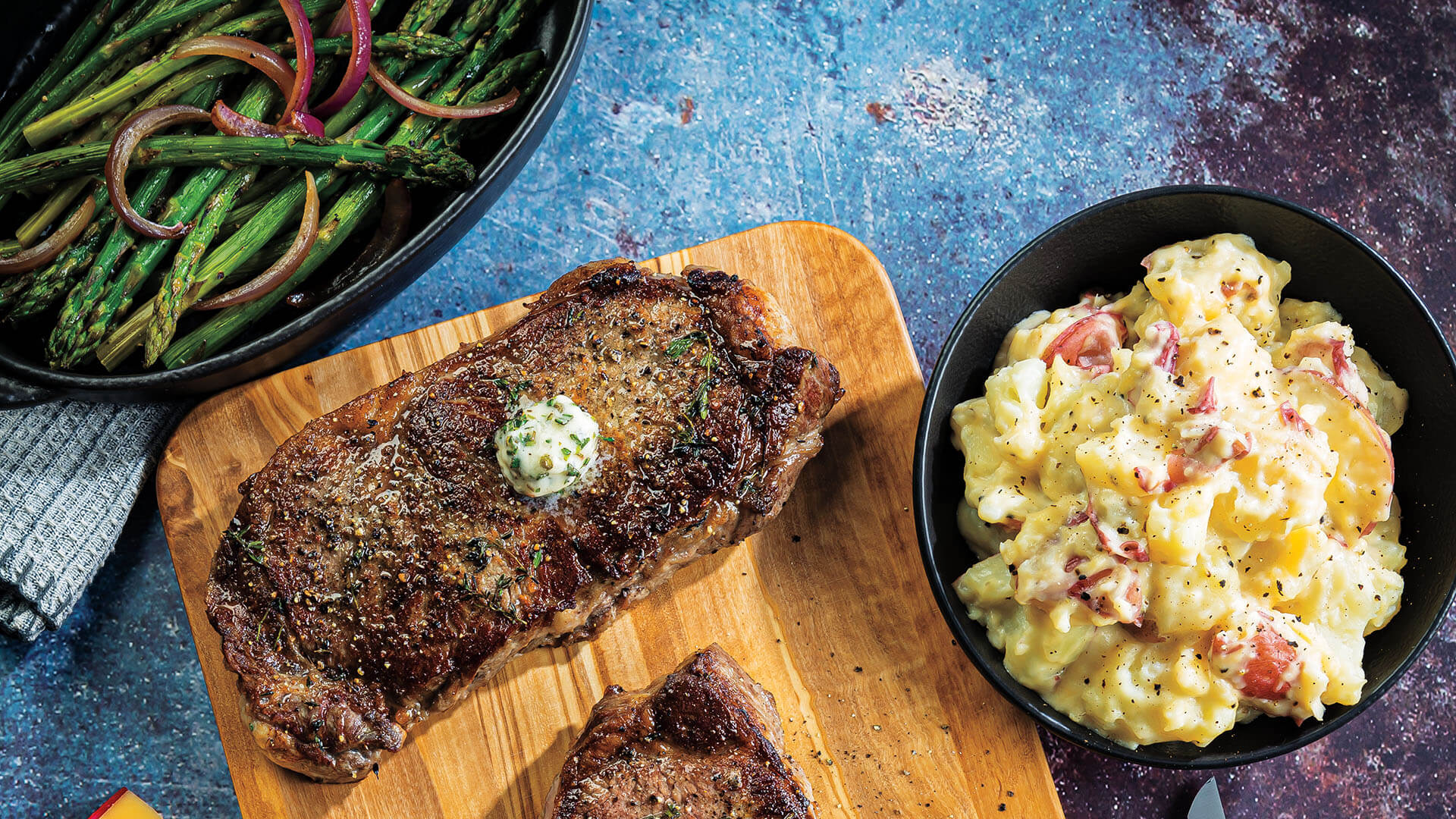 PanRoasted Strip Steaks with Gouda Smashed Redskins & Asparagus Roche Bros