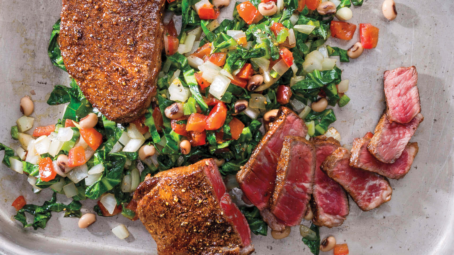 Oven-Roasted Berbere-Spiced New York Strip Steak with Collard Greens