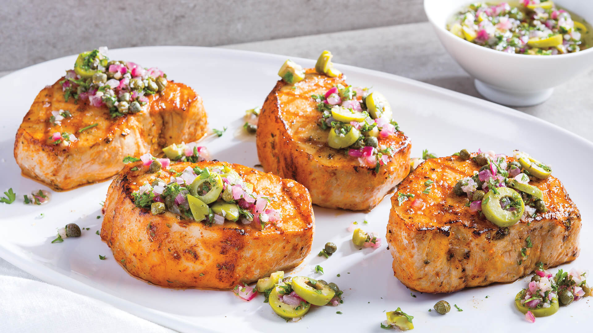 Spice-Rubbed Grilled Pork Chops with Spanish Olive-Caper Sauce