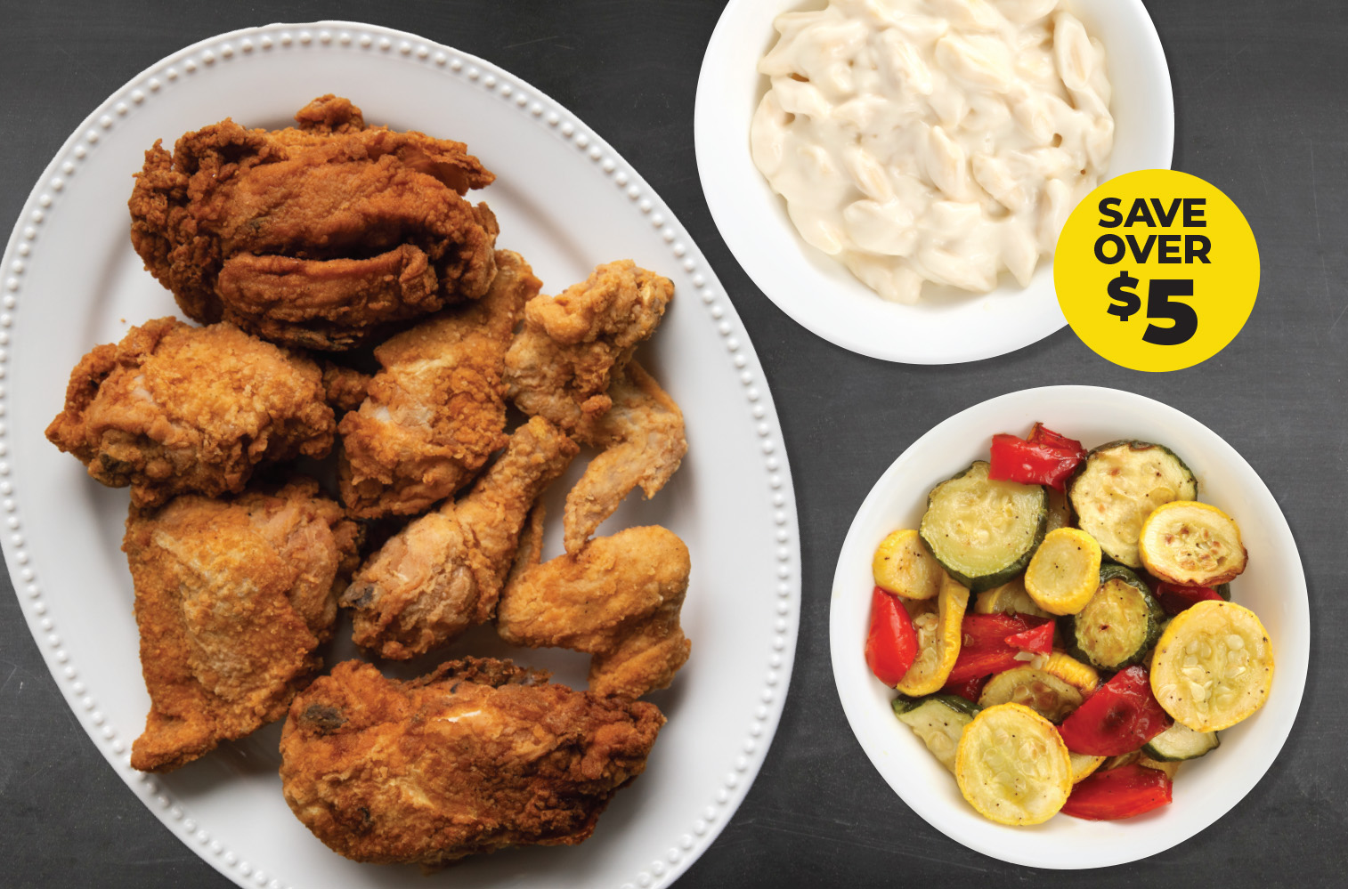 8-Piece Chicken Meal Deal featuring crisp fried chicken with sides of creamy Asiago mac and cheese and roasted vegetables, with a yellow badge reading "Save over $5".